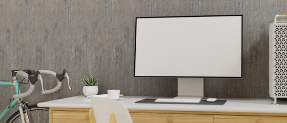 Computer monitor with mock-up screen on the desk in home office with bicycle, 3D rendering