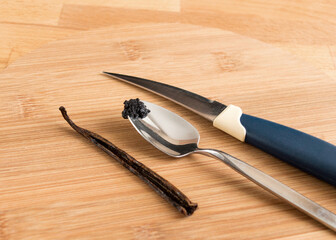 The vanilla beans were taken out of the pod. Wooden background, nobody