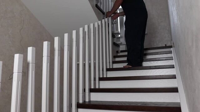 installation of balustrades by a master on a flight of stairs. Installation work on the stairs