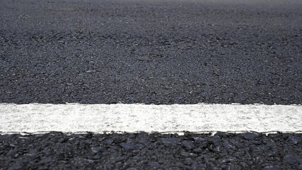 Surface rough of asphalt, Grey with white line on grainy road, Texture Background, Close up