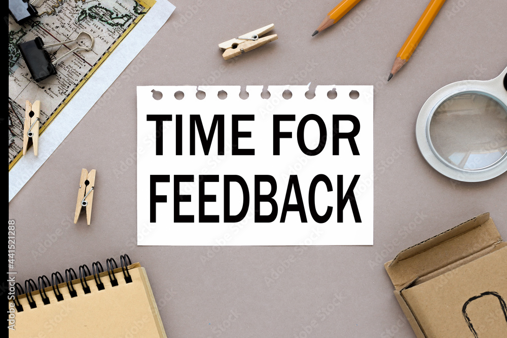 Poster time for feedback. text on notepad near magnifier and card with notepad