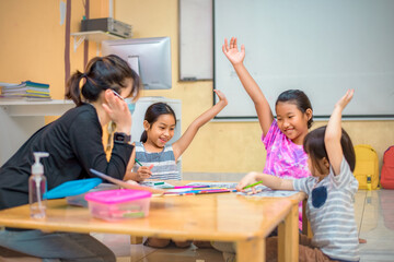Education after coronavirus epidemic. Children, students are practicing drawing, practicing their coloring skills and having fun with each other. with a homeroom teacher to teach learning skills.