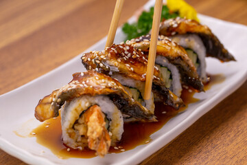 Japanese Sushi Unagi maki roll set with chopsticks.