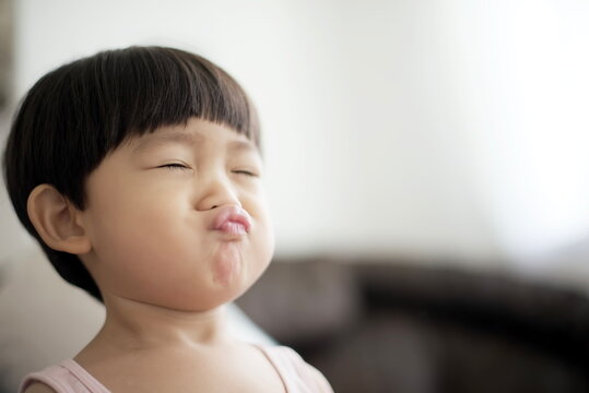 Little asian boy making lips to kiss : close up