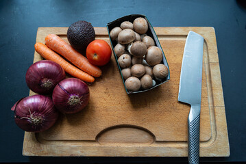 Vegetables on Wooden Board with Knife. Kitchen Concept. Vegan Concept