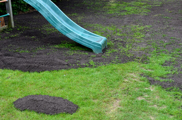 repair of damaged lawns after installation of automatic irrigation. bringing piles of soil and...