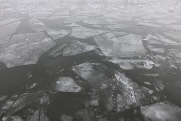 Broken large pieces of ice on a dark water of the Dnieper river