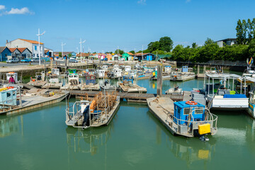 Fototapeta na wymiar Oyster farming boats in harbour at Oleron Island, Atlantic coast France in Charente-Maritime