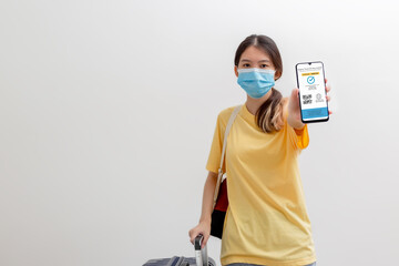 Vaccine passport, Woman wearing mask and holding smartphone showing health passport of vaccination...