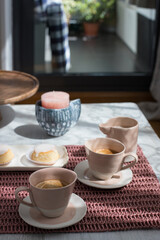 Home peaceful pink breakfast over a pinkish tablecloth on a wooden table.