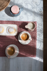 Elegant pink breakfast over a gray wooden table.