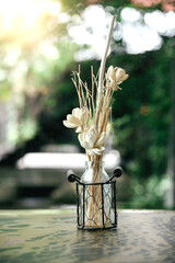 White Decoration Flowers In Glass Vase On The Table With Nature Background 