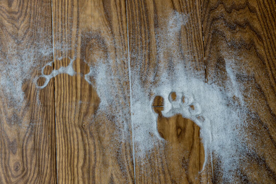 sandy footprints on the parquet