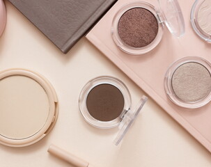 Make up layout,eye shadow, brush,  pastel pink background. Minimal and luxury make up, cosmetic or beauty salon composition. Flat lay, top view, copy space.