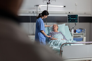 Fiendly doctor hands holding patient hand, in hospital room giving encouragement, empathy, support...