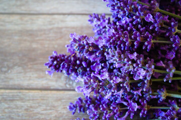 Lavender flowers, top view, isolated on wooden background