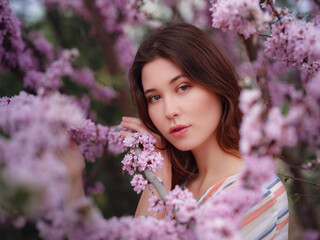 beautiful young asian woman enjoying the blooming of flowers in spring