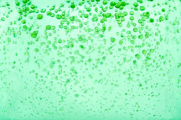 Mint green oil paint drops in water. Macro shot, abstract background with colorful ink and liquid....