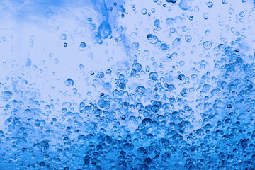 Beautiful colorful background with glitter and colored bubbles in oil and watercolor. Sparkle particles. Macro oil ink bubbles and drops. Abstract template acrylic paint texture. Colored wallpaper.