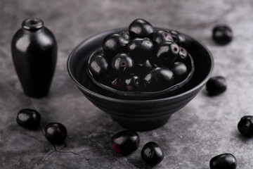 Indian Black Berry or Jamun Fruit, Java Plum in a Black Bowl - Healthy Fruit