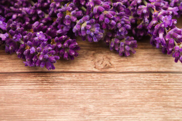 Fototapeta premium Close up of fresh blossoming lavender on rustic wooden background, with copy space