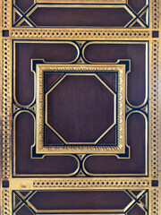 Wooden cassette door with gold plated or brass door handle knob and hinge enframed by wood, golden...