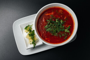 Traditional Ukrainian Russian borscht . Bowl of red beet root soup borsch with white cream . Beet Root delicious soup . Traditional Ukraine food cuisine