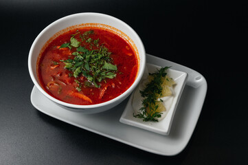 Traditional Ukrainian Russian borscht . Bowl of red beet root soup borsch with white cream . Beet Root delicious soup . Traditional Ukraine food cuisine