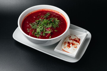 Traditional Ukrainian Russian borscht . Bowl of red beet root soup borsch with white cream . Beet Root delicious soup . Traditional Ukraine food cuisine