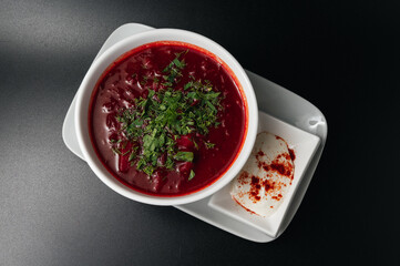 Traditional Ukrainian Russian borscht . Bowl of red beet root soup borsch with white cream . Beet Root delicious soup . Traditional Ukraine food cuisine