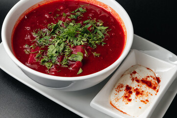 Traditional Ukrainian Russian borscht . Bowl of red beet root soup borsch with white cream . Beet Root delicious soup . Traditional Ukraine food cuisine