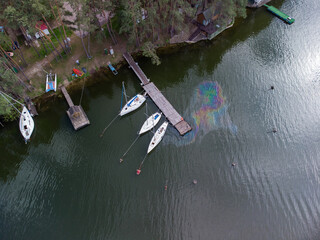 Aerial view of a water pollution. Oil stain on the water from the yacht. Environmental disaster.