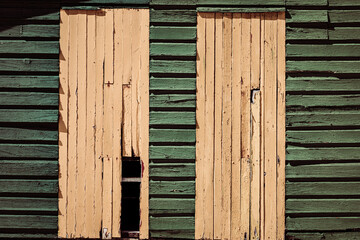 Macro texture of old faded paint on wooden timber planks
