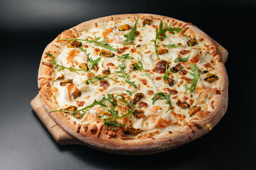Delicious seafood pizza with arugula