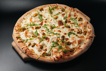 Delicious seafood pizza with arugula