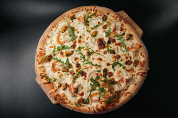 Delicious seafood pizza with arugula