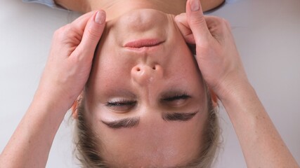 Chin massage of woman young woman during face massage at beauty salon