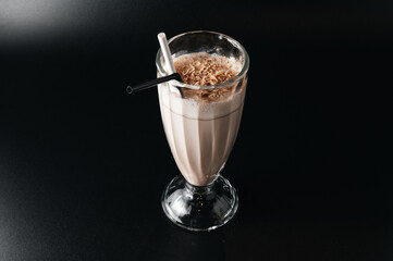 Closeup glass of milk shake isolated on black background