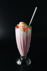 Closeup glass of milk shake isolated on black background