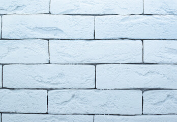 Brick wall is painted with light blue paint. Abstract texture for background.