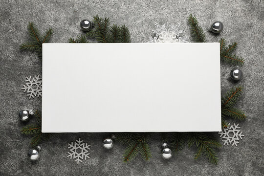 Flat lay composition with blank canvas and Christmas decor on grey background. Mockup for design
