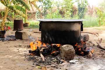 biryani preparation outdoor burning firewood on rocks nature garden outside fried rick cooking...