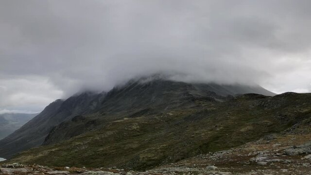 Handheld Slow motion footage of a foggy mountain peak. Summertime in the Norwegian mountains.