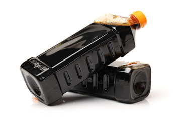 Bottle of soy sauce on white background