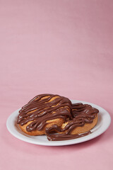 fresh pancake in a plate poured with chocolate paste, cream on buns, pancakes with chocolate