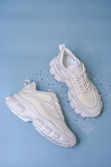 White chunky sole sneakers on a blue background