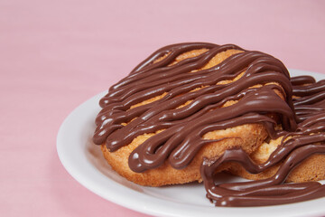 fresh pancake in a plate poured with chocolate paste, cream on buns, pancakes with chocolate