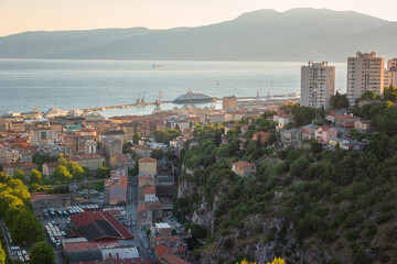 Scenic panoramic view of Rijeka port city on Adriatic seacoast from Trsat castle, beautiful cityscape in sunset light, Kvarner bay, Croatia. Outdoor travel background