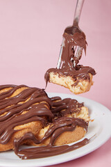fresh pancake in a plate poured with chocolate paste, cream on buns, pancakes with chocolate