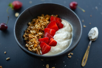 Homemade granola in bowl on dark